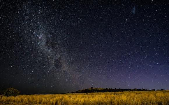 The night sky and Milky Way Galaxy with satellites
