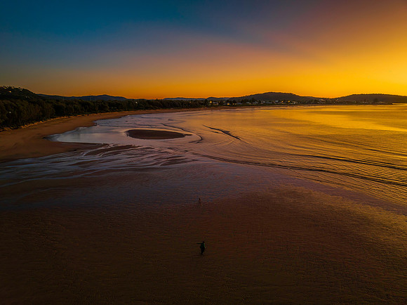Aerial sunrise seascape with orange glow on a cold Winter's morn