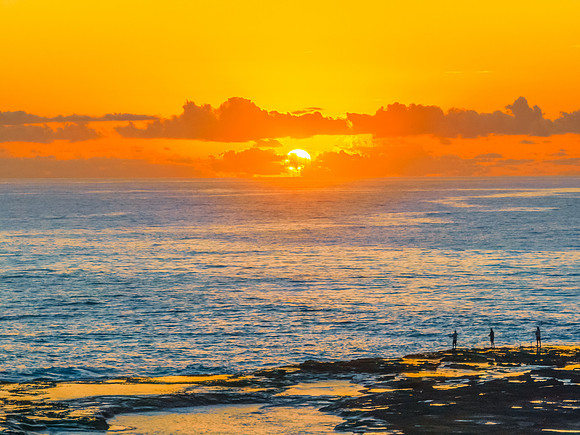 Sunrise over the sea and rocks with clear skies