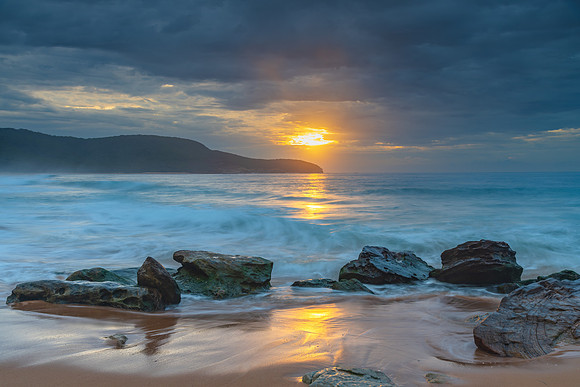 Sunrise at the seaside with rocks and beautiful diffused light b