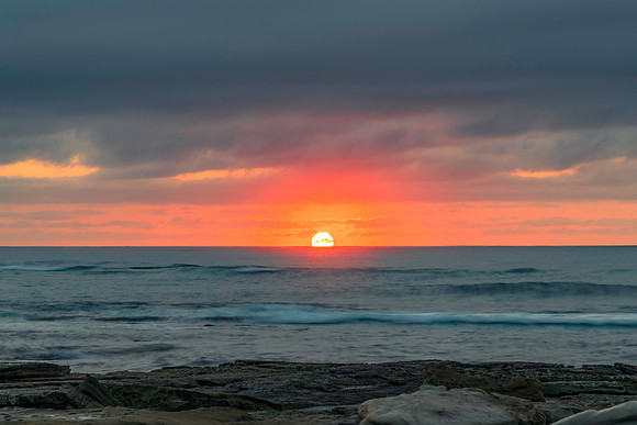 Sunrise seascape with rocky foreground