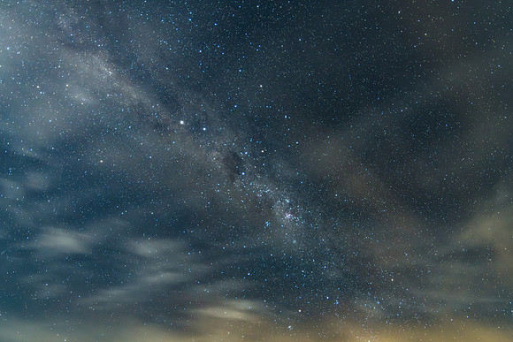 Stargazing at the night sky and milky way with high cloud
