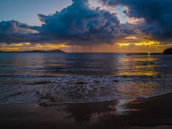Aerial sunrise at the seaside with rain clouds