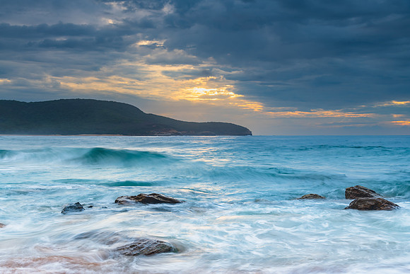 Sunrise at the seaside with rocks and beautiful diffused light b