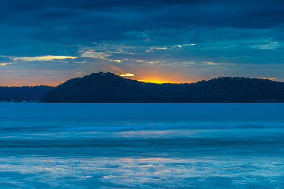 Colourful cloud filled sunrise at the seaside
