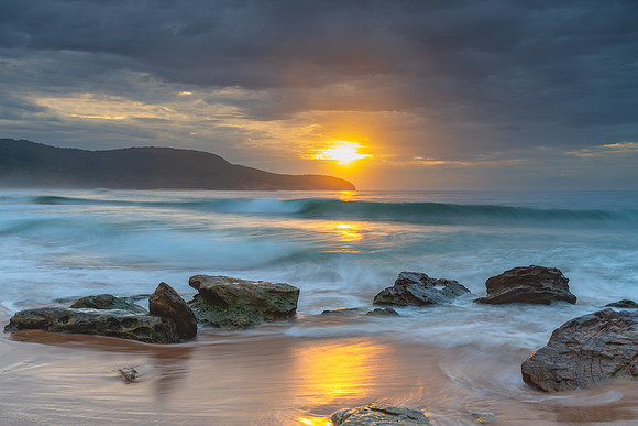 Sunrise at the seaside with rocks and beautiful diffused light b