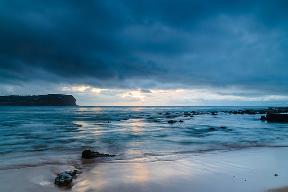 Cloud covered sunrise at the seaside