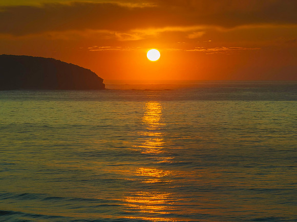 Golden path to the sun over the ocean
