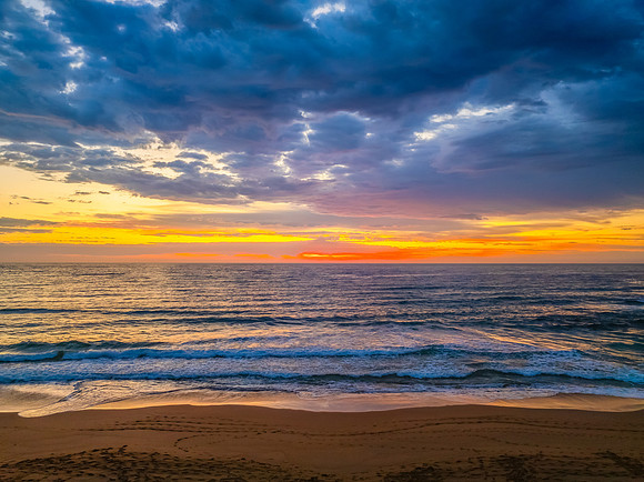 Pretty Sunrise at the seaside with rain clouds