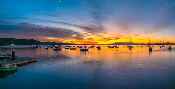 Aerial sunrise waterscape with boats and high cloud