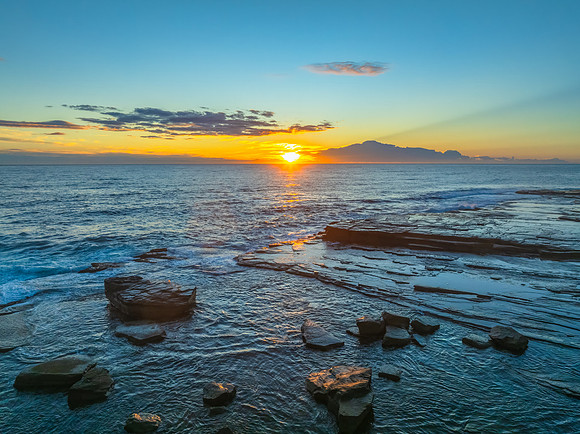 Sunrise over the ocean and rocky Inlet
