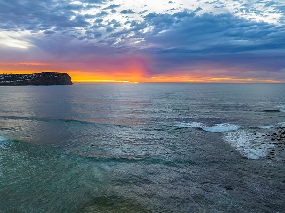Cloud filled sunrise seascape