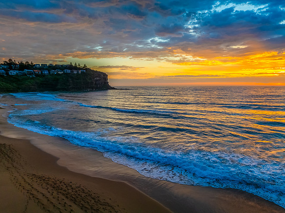 Pretty Sunrise at the seaside with rain clouds