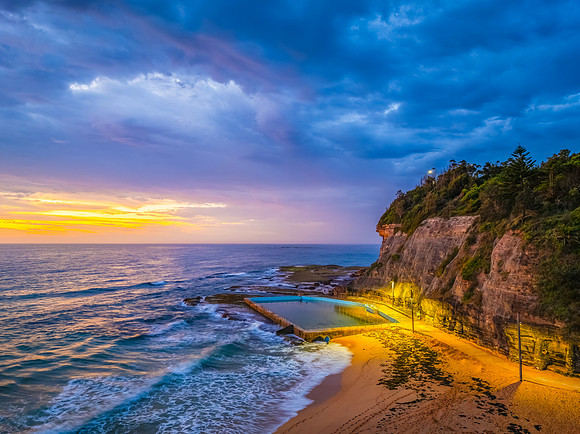 Pretty Sunrise at the seaside with rain clouds