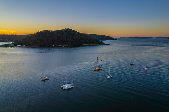 Aerial sunrise waterscape with boats and clear skies