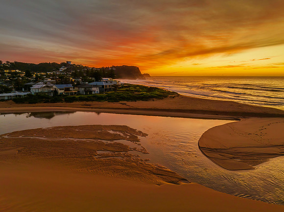 Sunrise and high cloud cover by the sea and lagoon