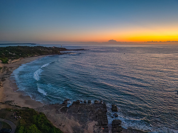 Sunrise over the sea and rocks with clear skies