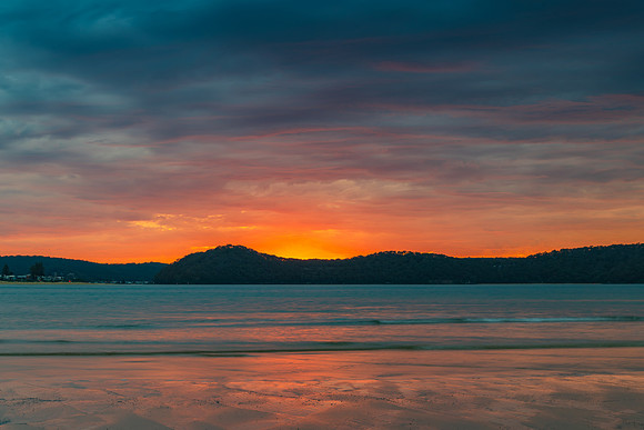 Colourful cloud filled sunrise at the seaside