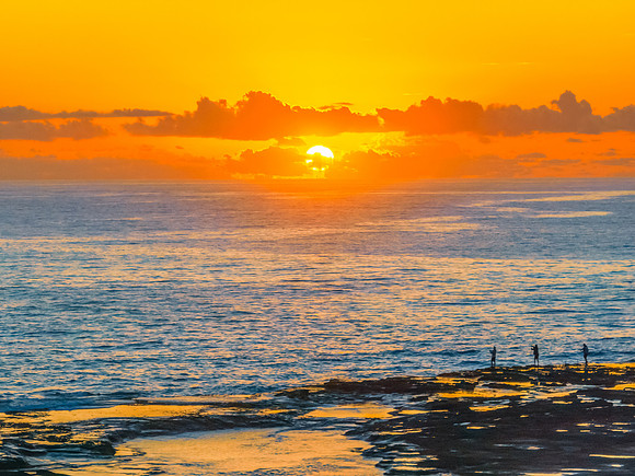 Sunrise over the sea and rocks with clear skies