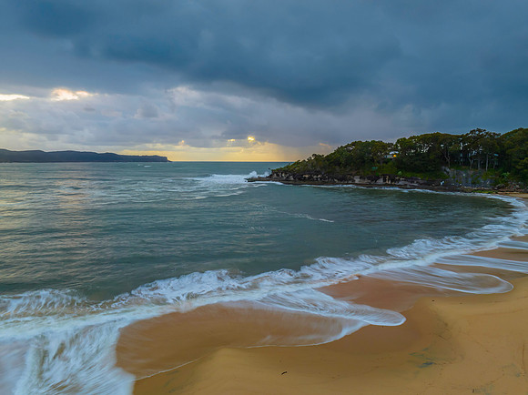 Sunrise seascape with overcast sky and rain clouds