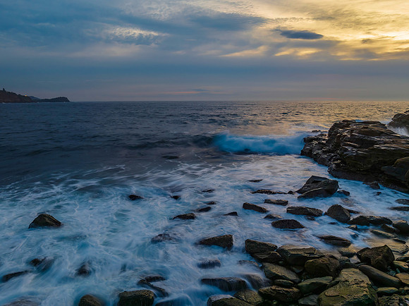 Dreamy soft-hued sunrise seascape over the ocean with high cloud