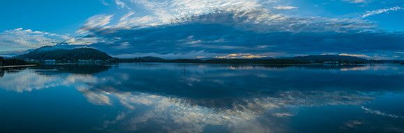 Respite from the rain - Bay waterscape panorama with reflections