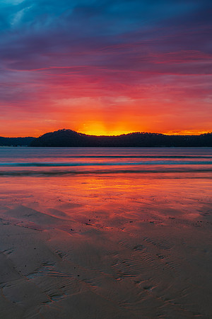 Colourful cloud filled sunrise at the seaside