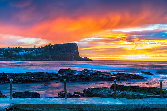 Winter sunrise by the sea pool with rain clouds