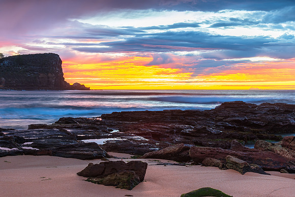 Winter sunrise by the sea shore with rain clouds