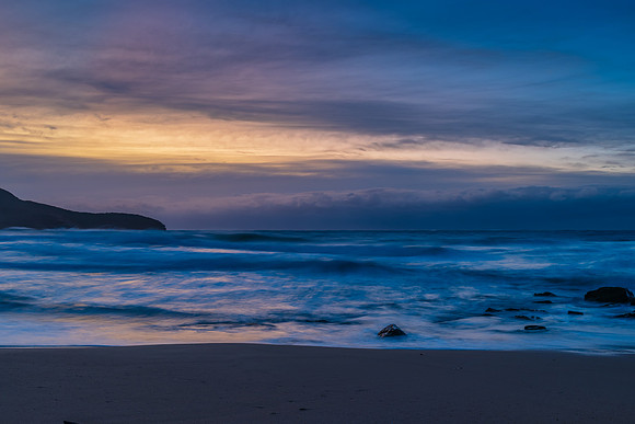 Cloud covered sunrise sesacape in soft pastel shades