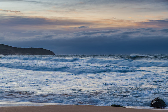 Cloud covered sunrise sesacape in soft pastel shades