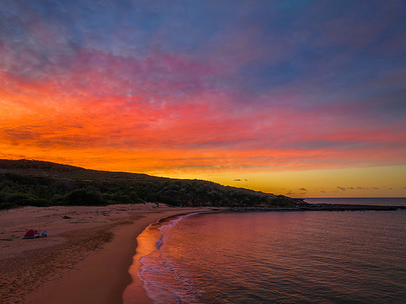 High cloud sunrise over the beach and mountain