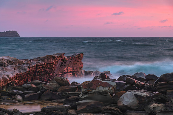 Cloud covered sunrise seascape with rocks