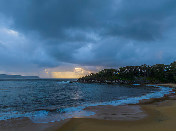 Sunrise seascape with overcast sky and rain clouds