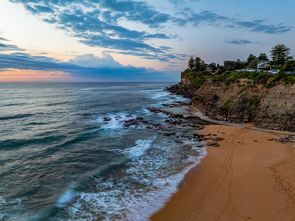 Seaside Sunrise Under a Cloud-Filled Sky
