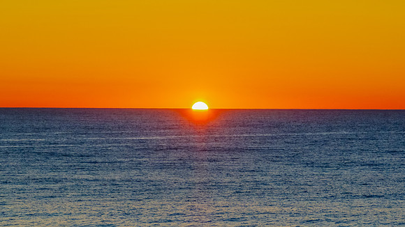 Sunrise at the seaside with a cloudless sky