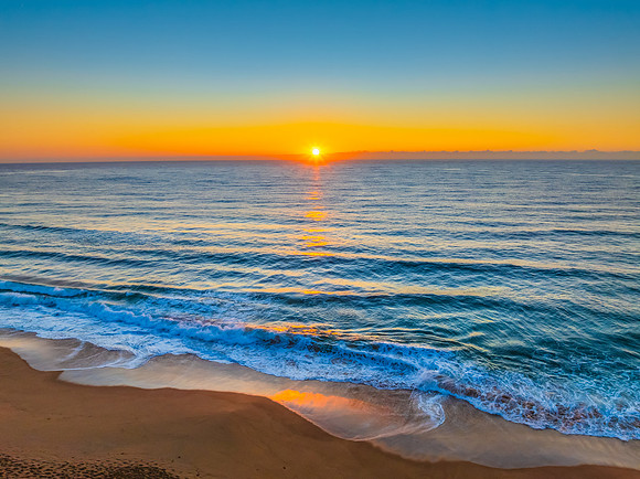 Sunrise at the Seaside with Clear Blue Skies