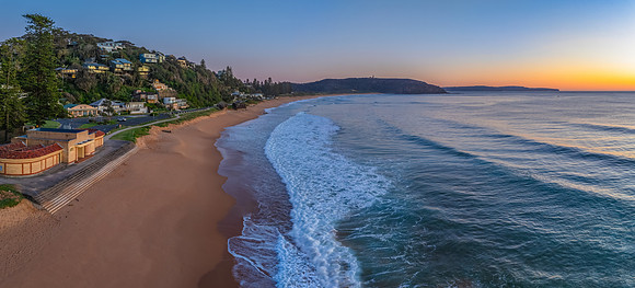Ocean Sunrise Under Clear Skies with Orange Horizon