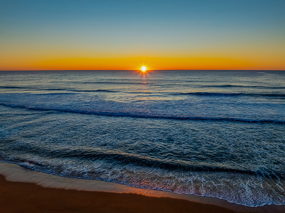 Sunrise at the seaside with a cloudless sky