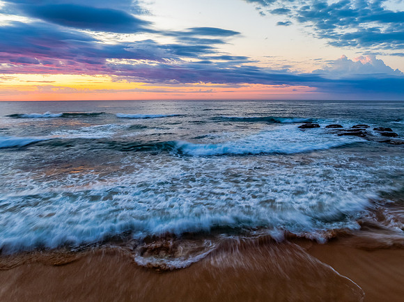 Seaside Sunrise Under a Cloud-Filled Sky
