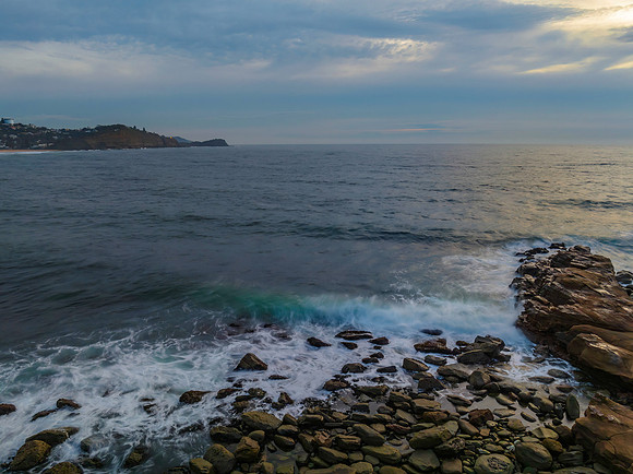 Dreamy soft-hued sunrise seascape over the ocean with high cloud