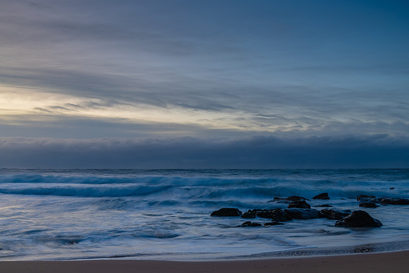 Cloud covered sunrise sesacape in soft pastel shades