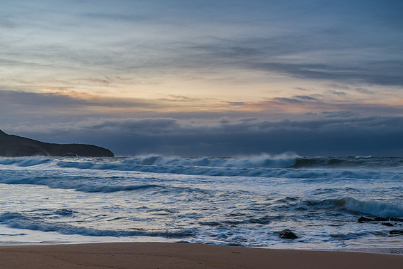Cloud covered sunrise sesacape in soft pastel shades