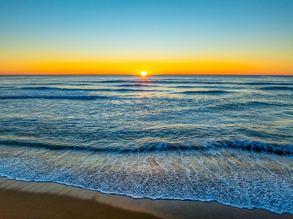 Sunrise at the seaside with a cloudless sky