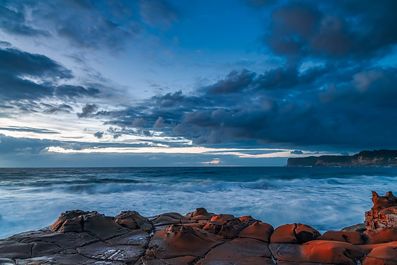 Sunrise, sea, waves, clouds and tessellated rock platform