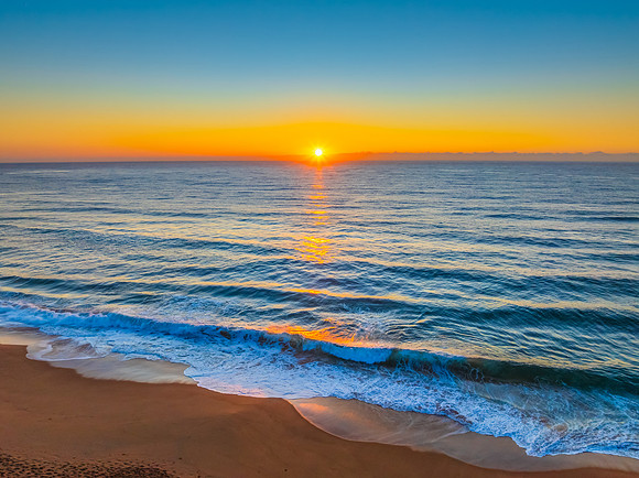 Sunrise at the Seaside with Clear Blue Skies