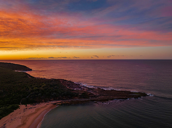 High cloud sunrise over the beach and mountain