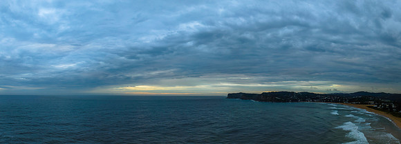 Rain clouds and a panoramic sunrise seascape