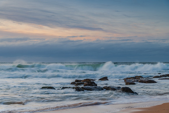 Cloud covered sunrise sesacape in soft pastel shades