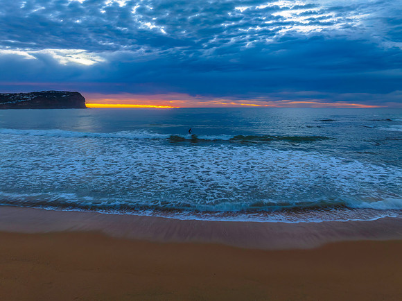 Cloud filled sunrise seascape